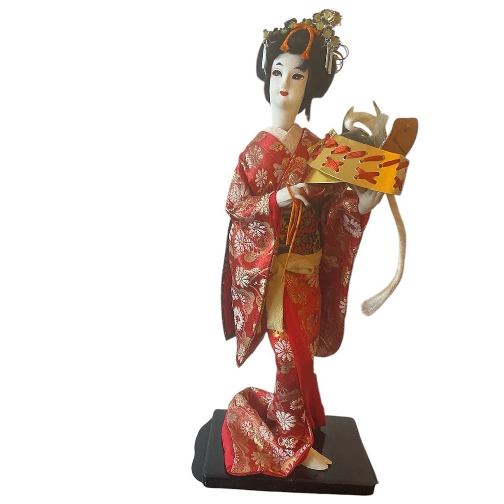 1964 Nishi Geisha Hand painted doll. Holding Samuri Helmet. Excellent condition.